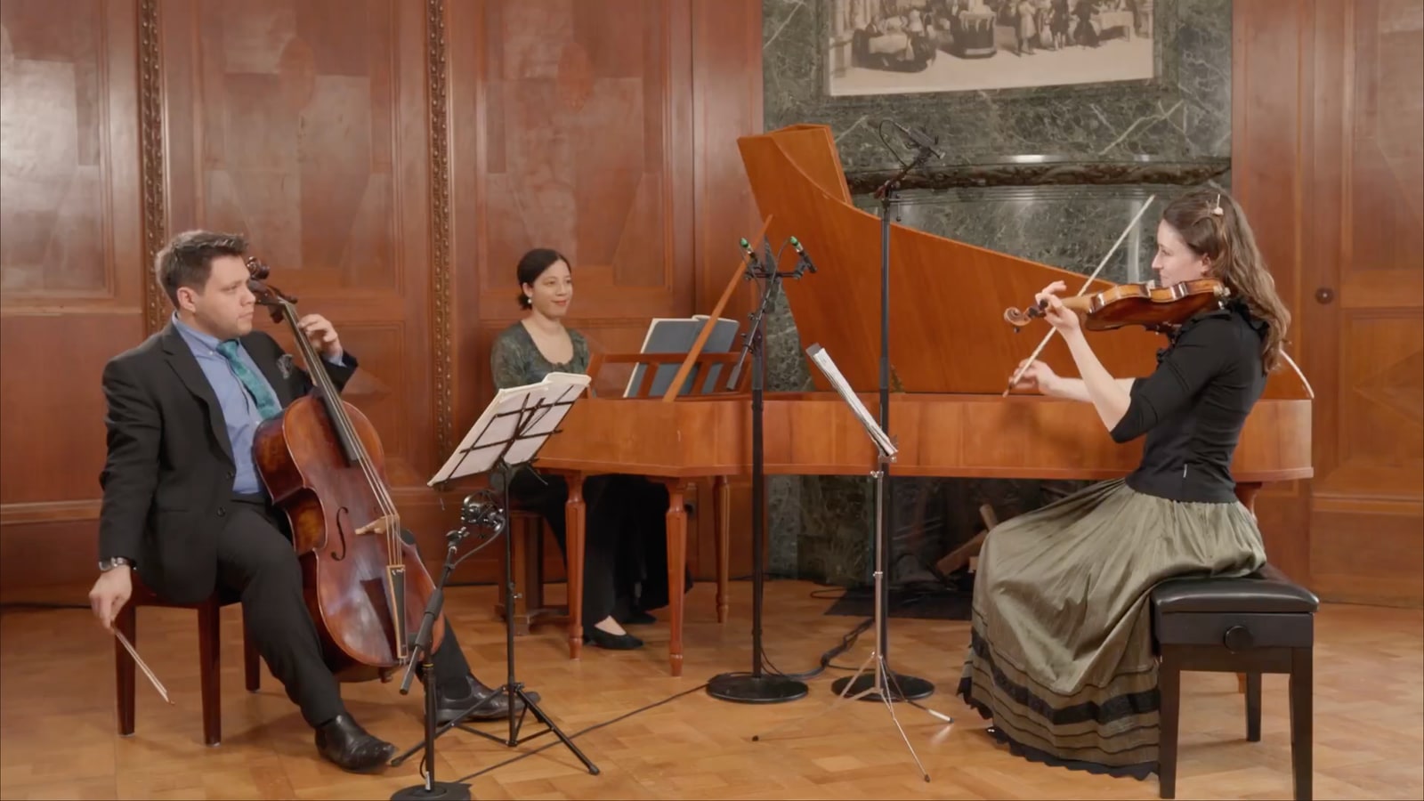 Chamber music setup with cello, piano and violin in a controlled recording room.