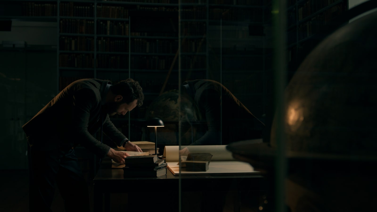Dark research and desk moment from the DaVinci Spec Spot.