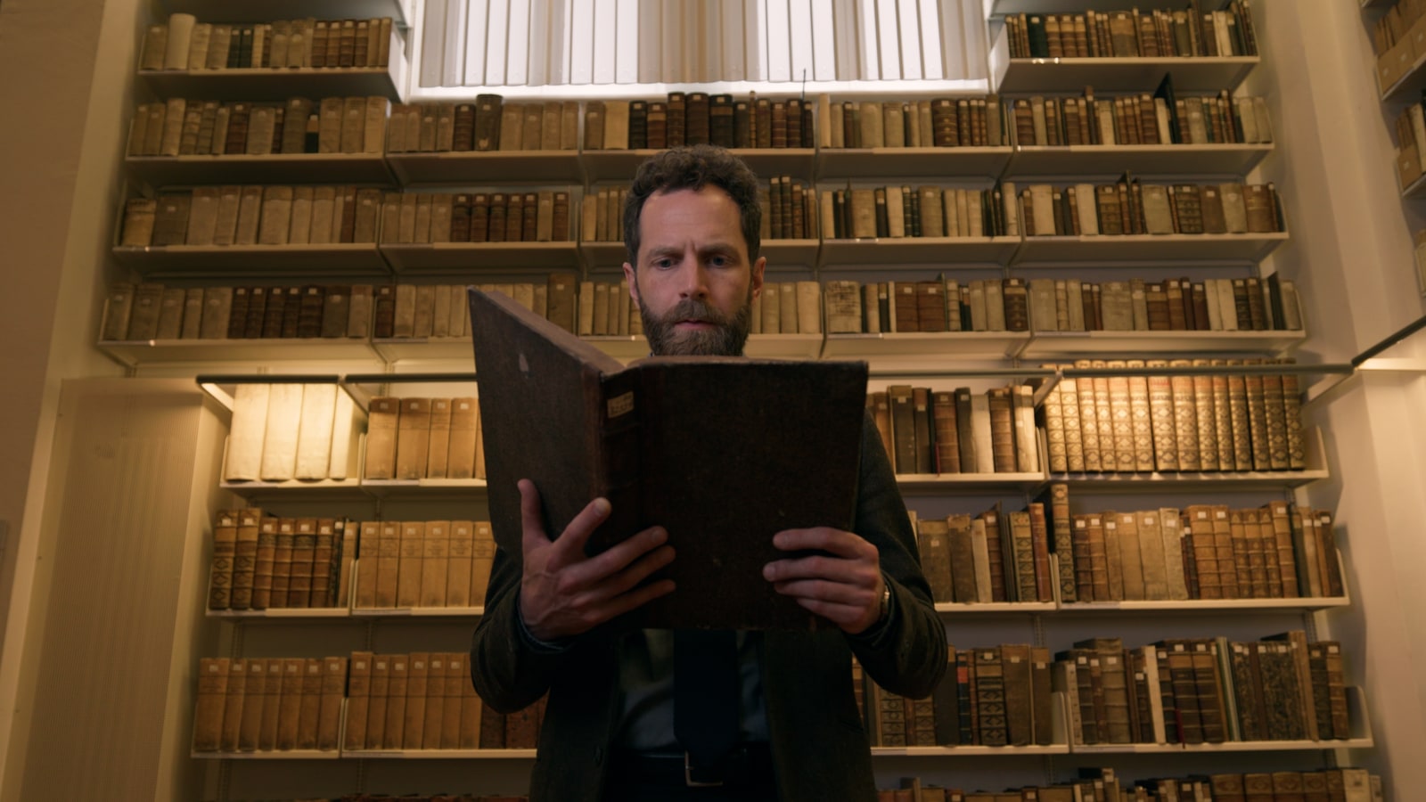 Centered character still with a book in the library from the DaVinci Spec Spot.