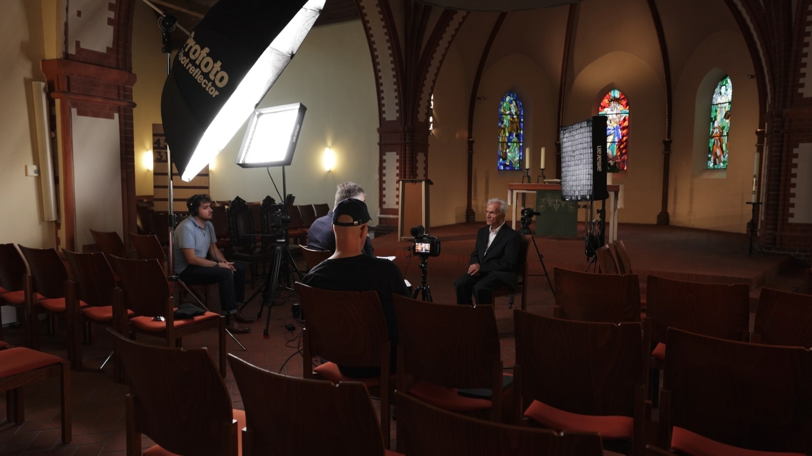 Wide setup still from the interview shoot inside the church.